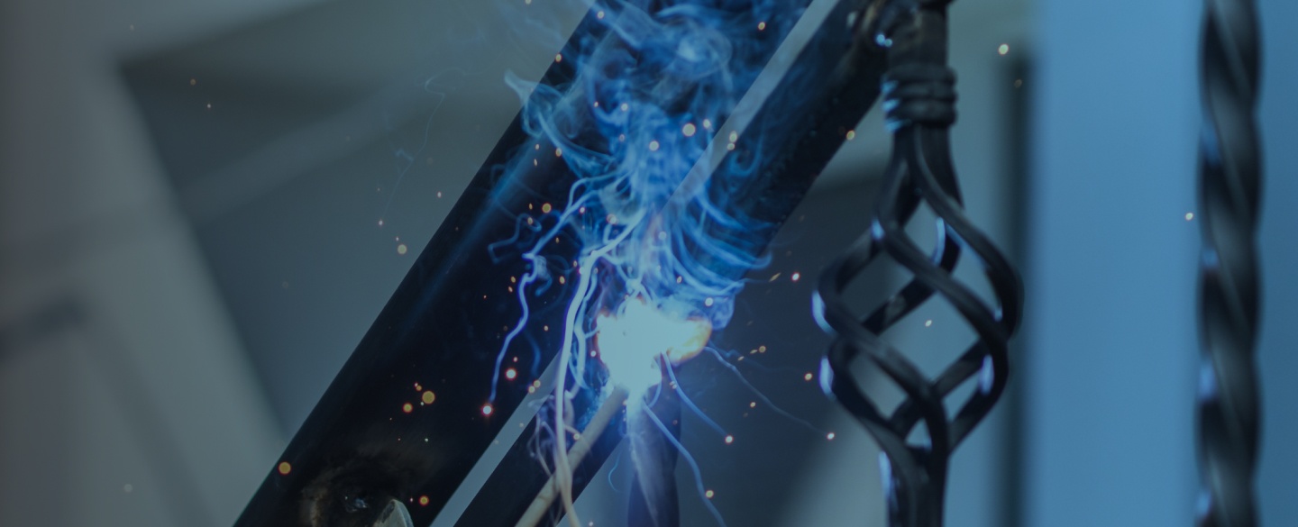 A worker welding metal handrails on the stairs in roy ut