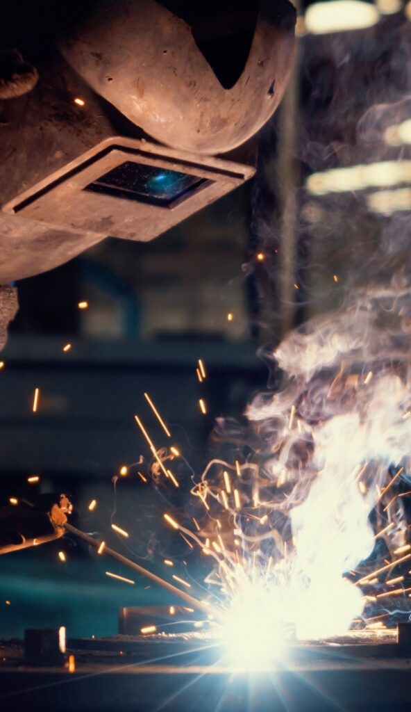 Skillful metal worker working with arc welding machine in factory roy ut